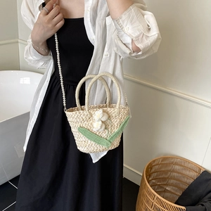 Women's straw woven handbag with floral decor and pearl chain for summer vacation