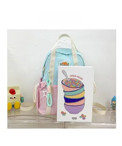 Detail of macaron-colored mini backpack with side drawstring pocket and star pendant