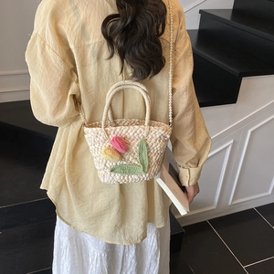 Summer straw handbag with tulip crochet decor and pearl chain strap on model