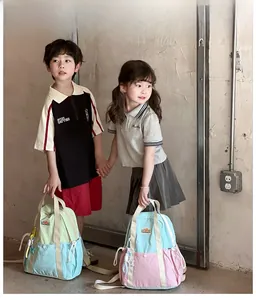 Lifestyle shot showing two children with large capacity color-block school backpacks