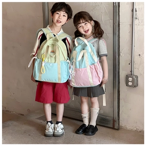 Detail of lightweight color-block backpacks on kids featuring durable nylon and web handles