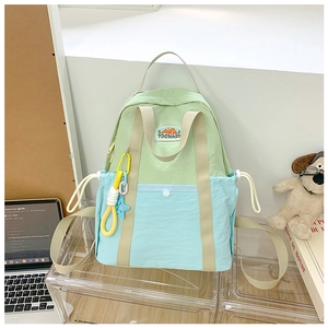 Detail of color-block kids backpack with star charms and Tochaso embroidered label
