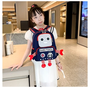 Asian girl wearing a navy blue robot-themed panda backpack in a cozy bookstore setting