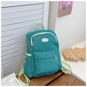 Detailed view of casual candy-colored kids backpack with contrast straps and brand logo