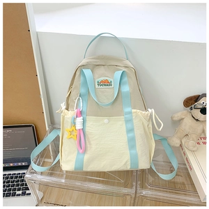 Detail of color-block children's backpack with star charm on a display shelf