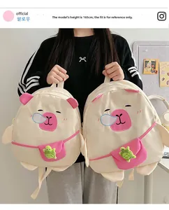 Detail of cute cartoon backpack featuring a sleeping pig design and green turtle charm