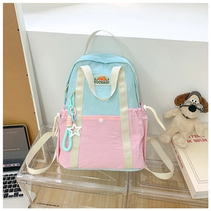 Detail of color-block children backpack with star charm and side drawstring cords
