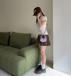 Close-up of light purple crescent moon shoulder bag with tulip charm on a girl