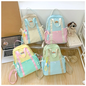 Detail of colorful macaron contrast schoolbags with drawstring pockets and cute charms