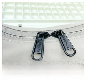 Detail of smooth black metal double zippers with logo engraving on kids crossbody bag