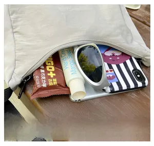 Spacious interior of kids' nylon crossbody bag showing storage for daily essentials