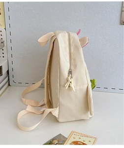 Detail of cream nylon kids backpack with pink side pockets and adjustable straps