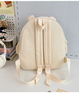 Detailed back view of beige kids backpack showing adjustable straps and cute bear ears