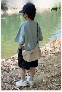 Kids casual beige dumpling crossbody bag with adjustable strap and logo detail