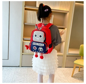 Rear view of a child wearing the red and blue robot panda backpack in a cozy study room