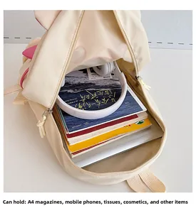 Spacious interior of beige cartoon backpack showing large capacity for A4 books and headphones