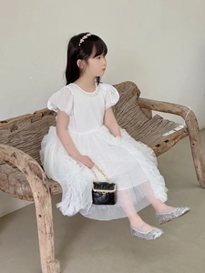 Detail of white girls princess dress with puff sleeves and pearl neckline decor