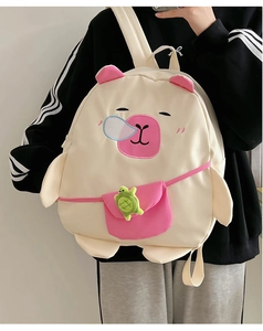 Detail of cute Capybara backpack for kids featuring pink ears and a turtle charm