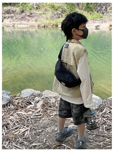 Dettaglio borsa a tracolla nera per bambini con trama in nylon e tracolla regolabile