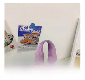 Detail of comfortable purple woven handle on light blue school backpack with reinforced stitching