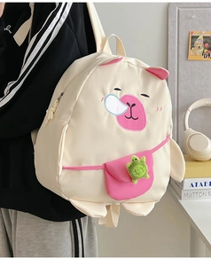 Detail of cute Capybara backpack for kids with a green turtle charm and pink accents
