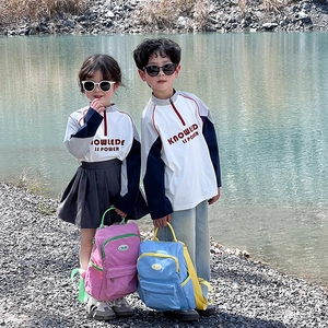 Minimalist kids' candy color backpack shown in an outdoor park setting for school and travel