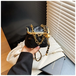 Detailed close-up of a mini quilted crossbody bag with gold hardware and chain strap