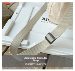 Detail of adjustable beige nylon strap with black plastic buckle for kids travel bag