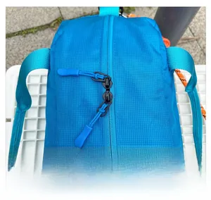 Detail of durable blue ripstop fabric and smooth dual zipper on outdoor travel bag