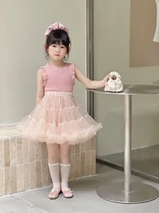 Detail of sweet pink sleeveless top with bow and layered fluffy tulle skirt for girls