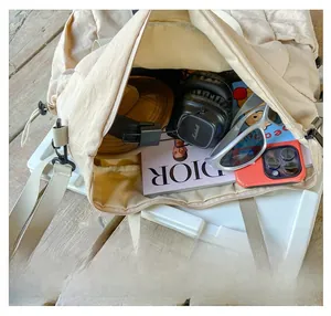 Spacious interior of the beige nylon travel bag with gadgets and lifestyle essentials