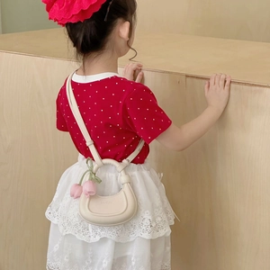 Cream crescent shoulder bag for girls with tulip charm and adjustable strap shown on model