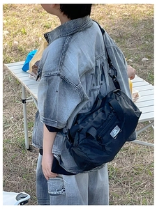 Outdoor black nylon shoulder bag with adjustable strap and brand label for kids