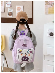Detail shot of lightweight purple school bag with cute 3D cartoon bear pocket on the back