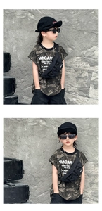 Detail of black nylon kids chest bag showing drawstring pocket and adjustable strap