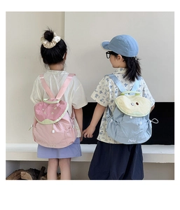 Detail of pink strawberry and blue pear children's drawstring backpacks in nylon fabric