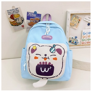Close-up of light blue kids backpack featuring a cute white cartoon bear and purple handle