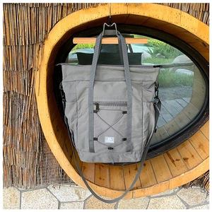 Detail of grey travel tote bag with front zipper pocket and adjustable shoulder strap