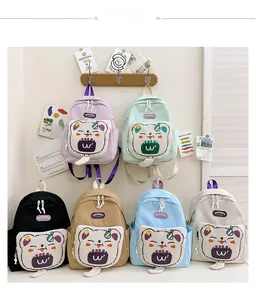 Detailed close-up showing six colorful kids backpacks with cute 3D bear pockets