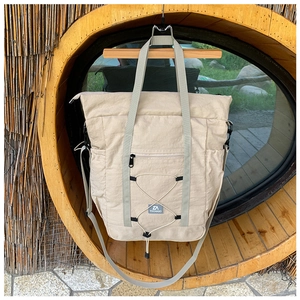 Detail of khaki nylon kids travel bag with adjustable strap and drawstring design