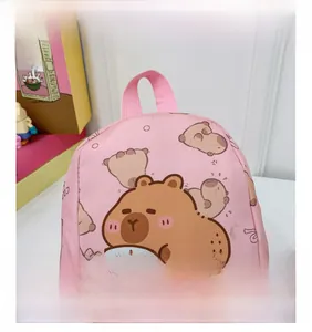 Detailed view of pink canvas backpack with cute capybara and fish cartoon patterns