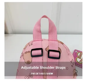 Close-up of adjustable pink straps and handle on cartoon bear kids backpack