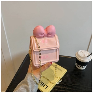 Mini sac bandoulière rose en cuir avec grand nœud et chaîne dorée pour fillettes