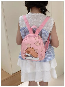 Close-up of pink toddler backpack featuring cute cartoon capybara print and adjustable straps