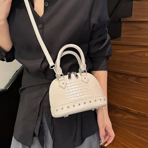 Mini shell crossbody bag with crocodile pattern and rivet details in creamy white