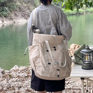 Large beige kids travel tote bag with drawstring detail for outdoor camping and hiking