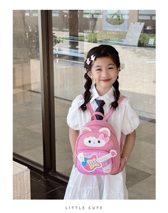 Pink cartoon cat backpack for kids with glitter bow and guitar pattern on model