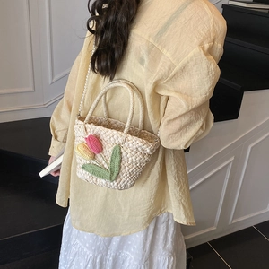 Handmade woven straw beach bag with crochet tulips and pearl strap for summer vacations