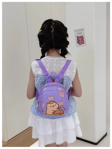 Rear view of a purple mini backpack for toddlers featuring a cute cartoon capybara print