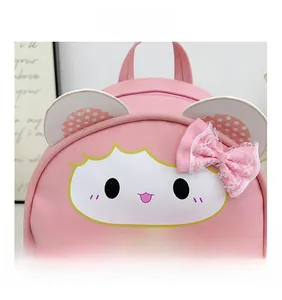 Detail of pink cartoon kid's backpack featuring lace bow, sequins, and cute animal face